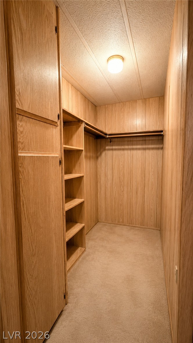 2764 Rainer Court Las Vegas, NV 89142 - Photo 6 of 13 A well-appointed walk-in closet offers ample storage with built-in shelving, cabinetry and hanging space.