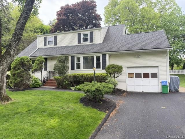 17 Mallory Road Spring Valley, NY 10977 - Photo 3 of 26 a front view of a house with a garden and trees