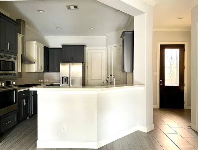 a view of a kitchen with a sink and cabinets