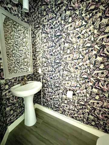 a bathroom with a sink toilet and a mirror