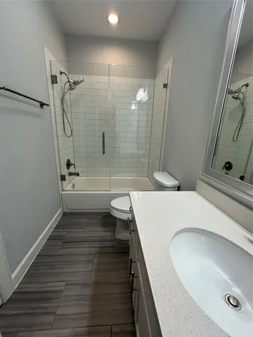 a bathroom with a double vanity sink toilet and shower