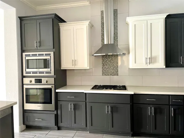 a kitchen with stainless steel appliances granite countertop a sink and a microwave