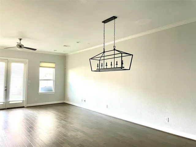 a view of a room with a window and wooden floor