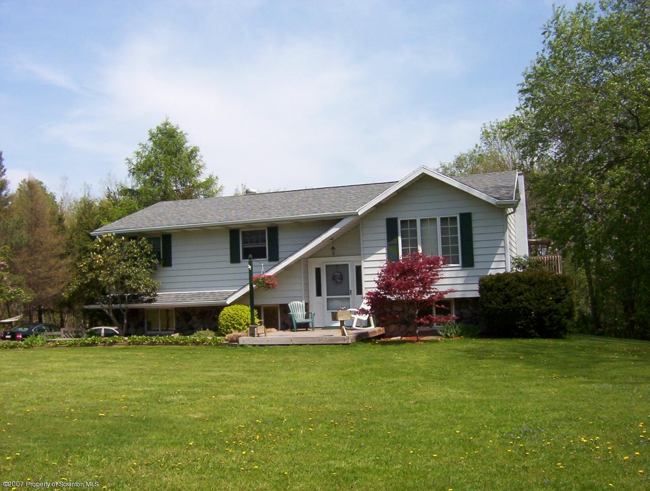 4 Rr Road Lake Ariel, PA 18436 - Photo 1 of 12 a front view of a house with a garden