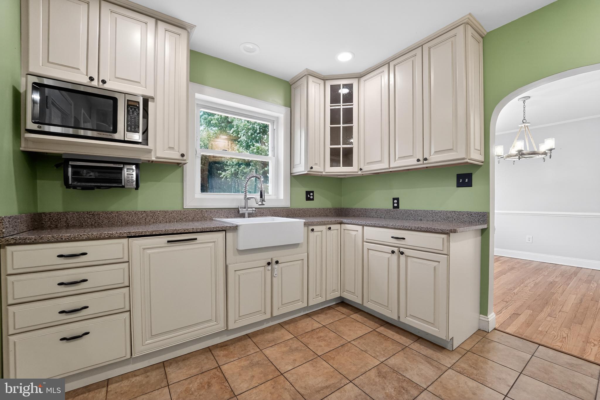 9408 Dana Vista Road Baltimore, MD 21236 - Photo 13 of 38 a kitchen with granite countertop white cabinets stainless steel appliances and a window