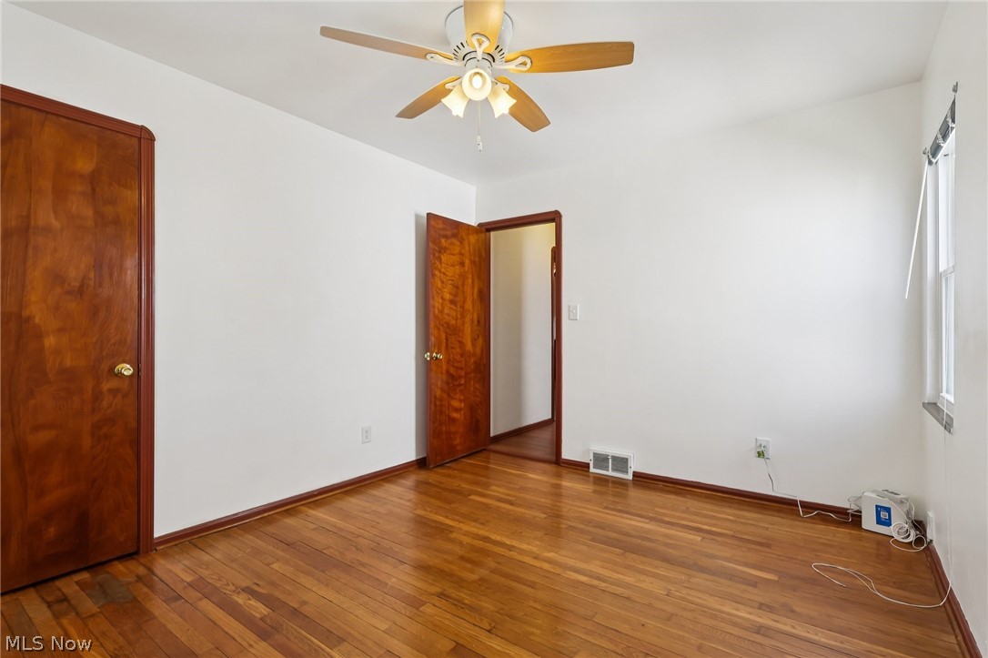 4252 Ridgeview Road Cleveland, OH 44144 - Photo 12 of 37 Unfurnished room featuring dark wood-style flooring and a ceiling fan