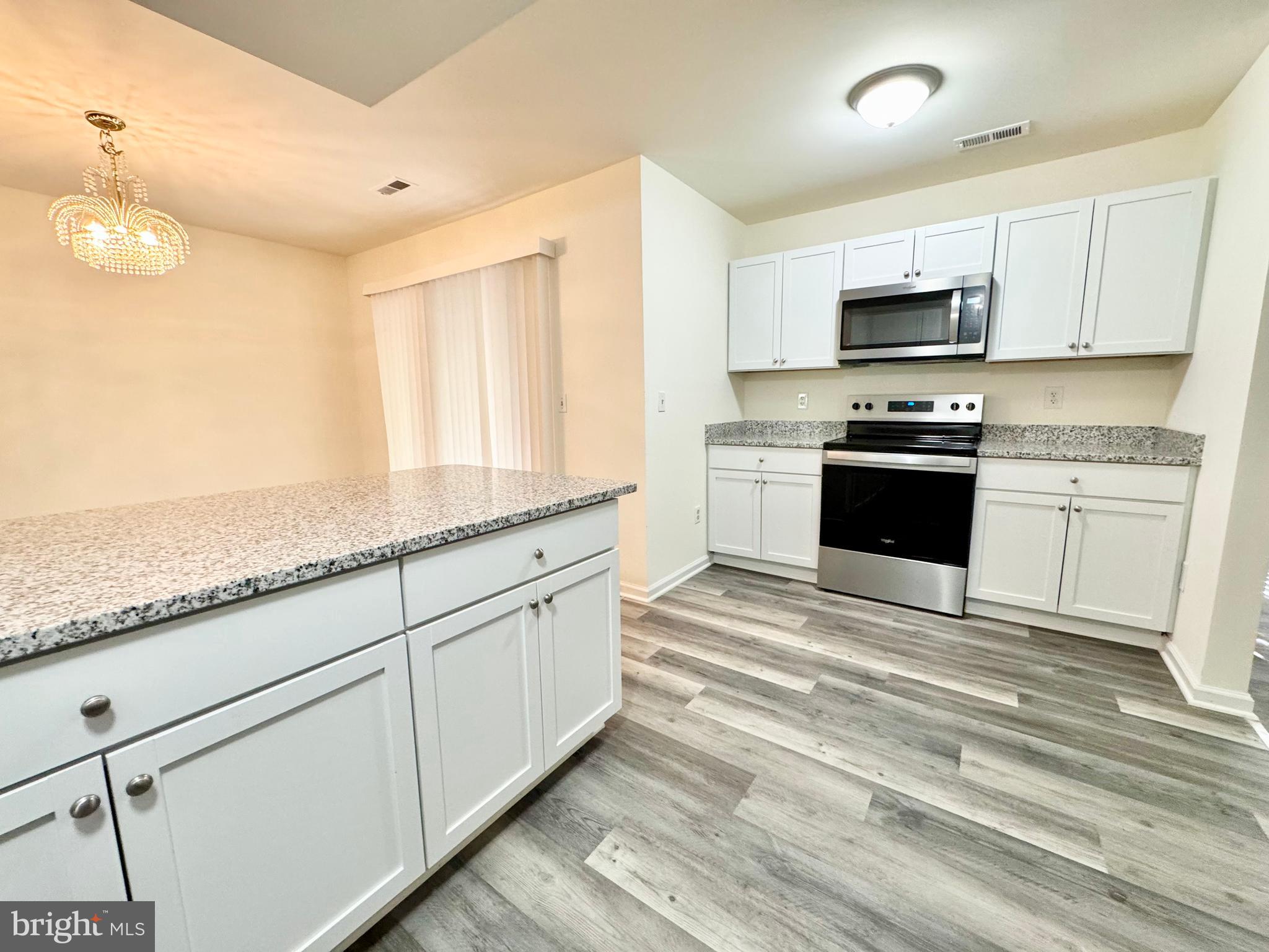 271 Pine Valley Road Dover, DE 19904 - Photo 11 of 24 a large kitchen with stainless steel appliances granite countertop a stove and a sink