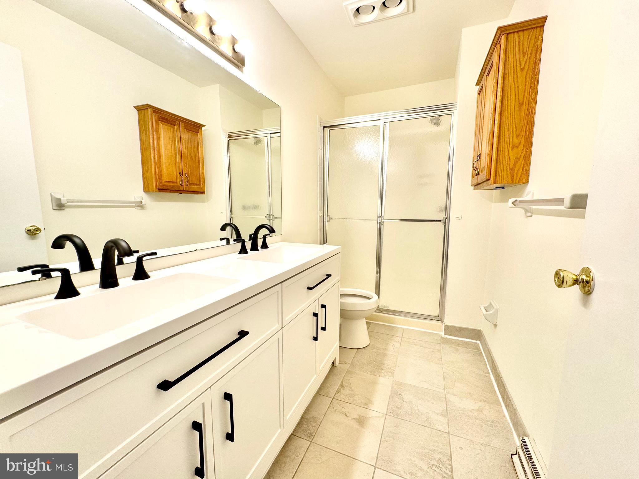 271 Pine Valley Road Dover, DE 19904 - Photo 21 of 24 a spacious bathroom with a double vanity sink a mirror and a shower