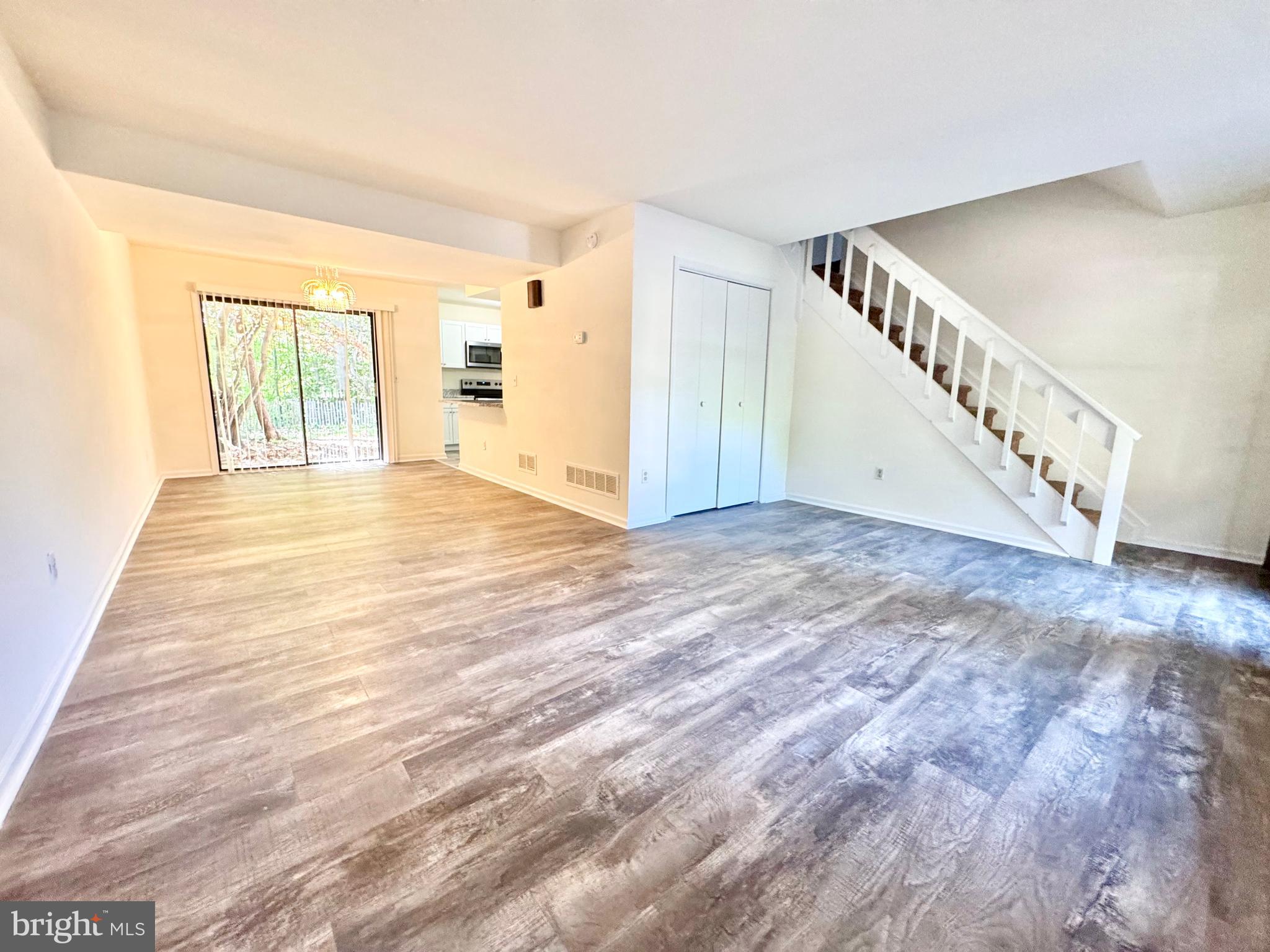 271 Pine Valley Road Dover, DE 19904 - Photo 5 of 24 a view of an empty room with wooden floor and stairs