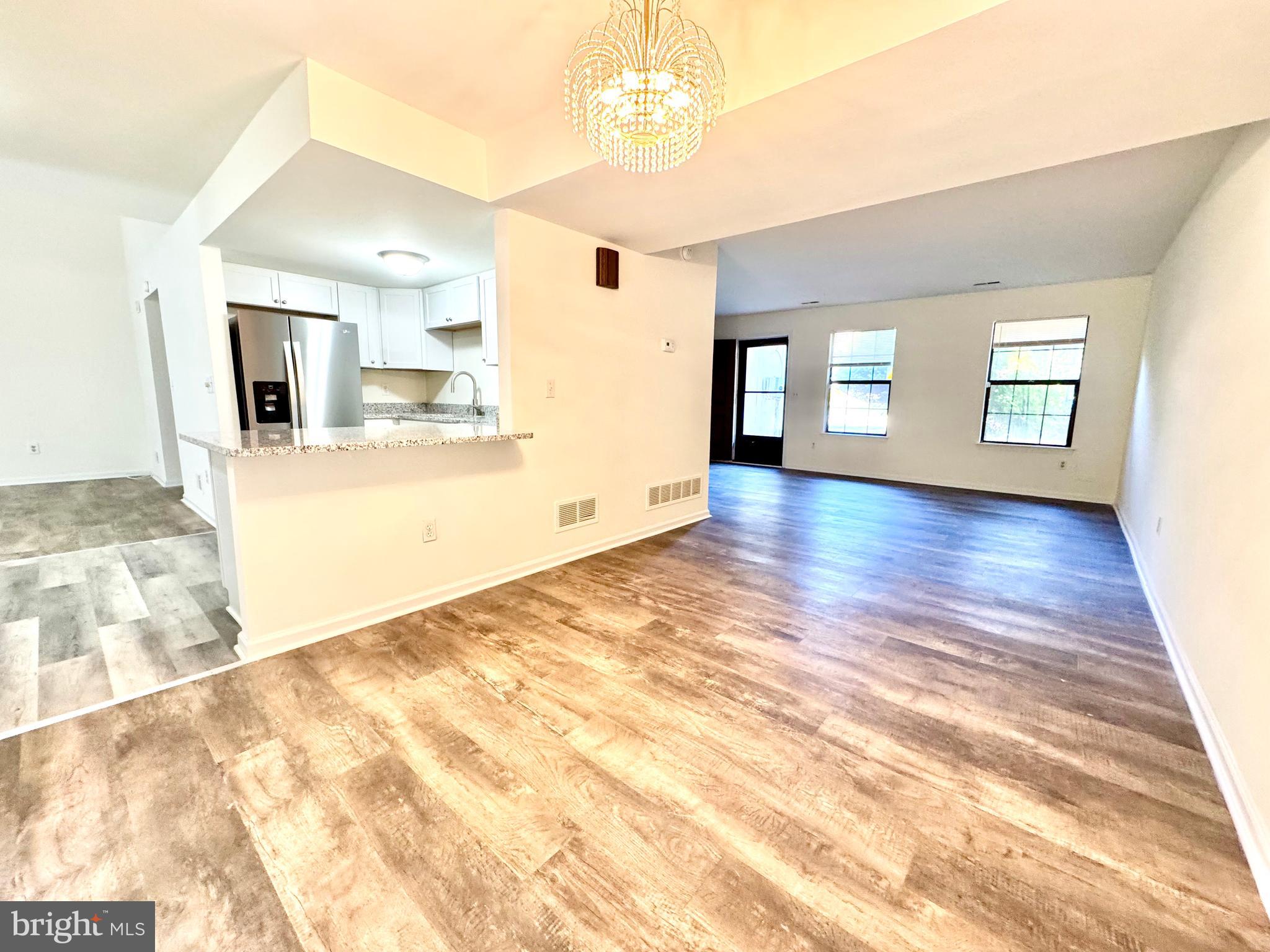 271 Pine Valley Road Dover, DE 19904 - Photo 8 of 24 a view of a big room with wooden floor and windows