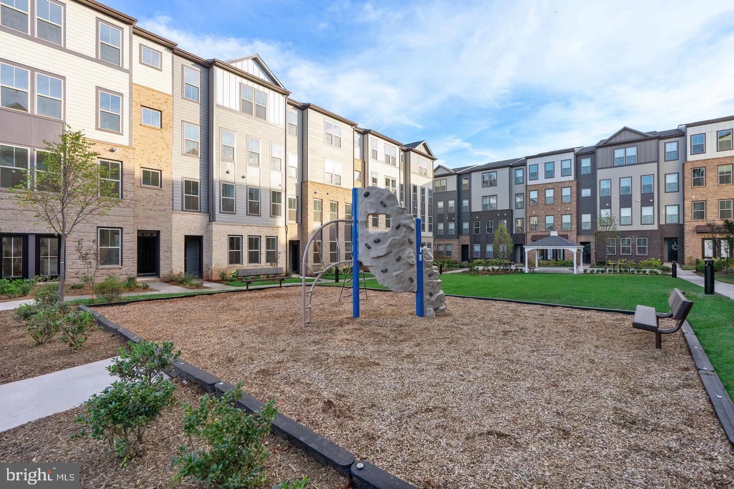 20957 Bluebird Square Sterling, VA 20165 - Photo 15 of 18 a view of a building with a yard