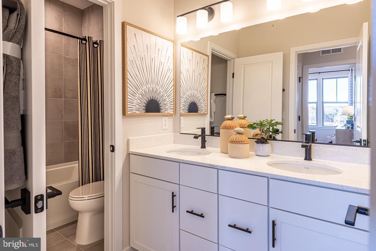 20957 Bluebird Square Sterling, VA 20165 - Photo 8 of 18 a bathroom with a granite countertop sink a toilet and a mirror