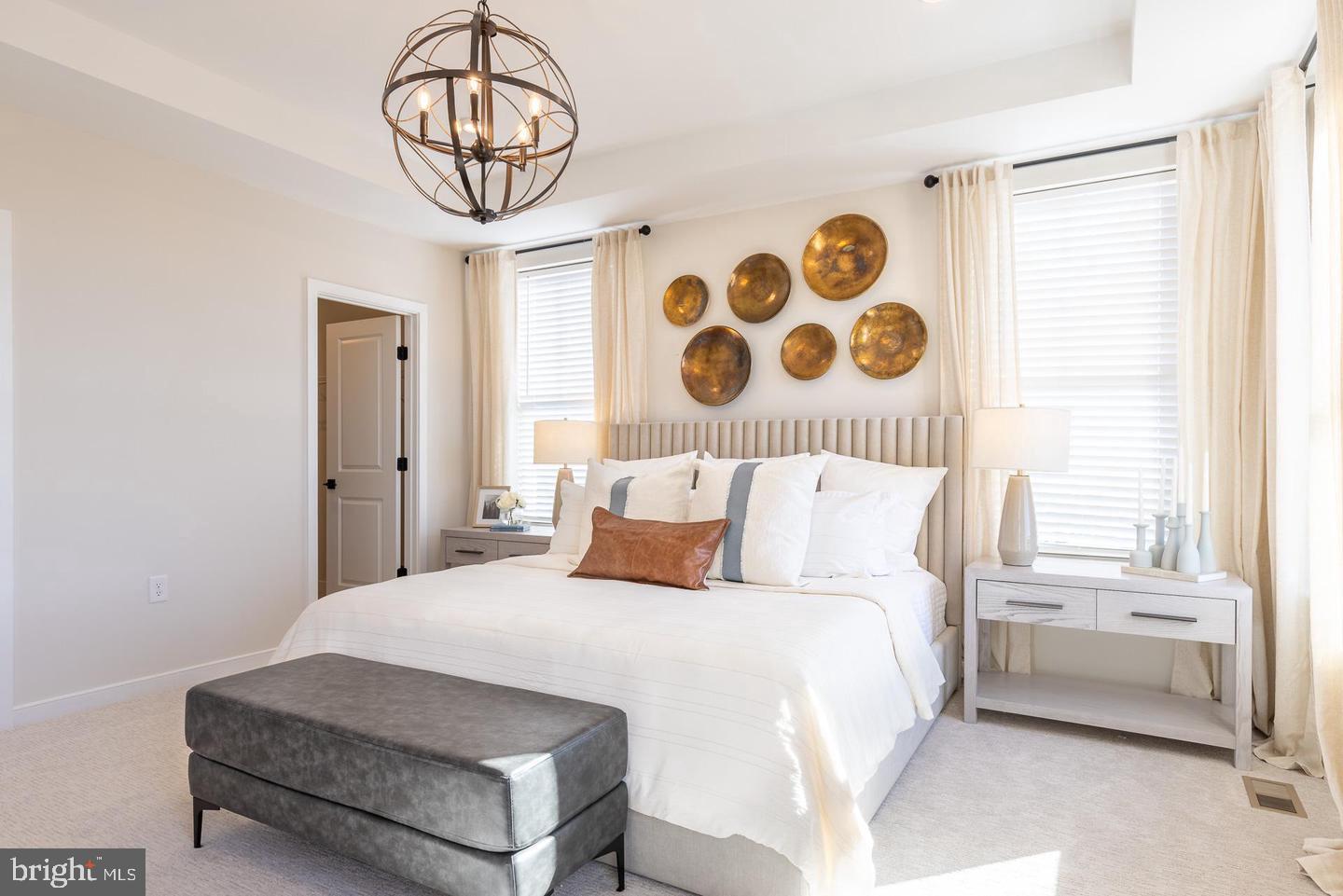 20957 Bluebird Square Sterling, VA 20165 - Photo 9 of 18 a bedroom with a bed and a chandelier