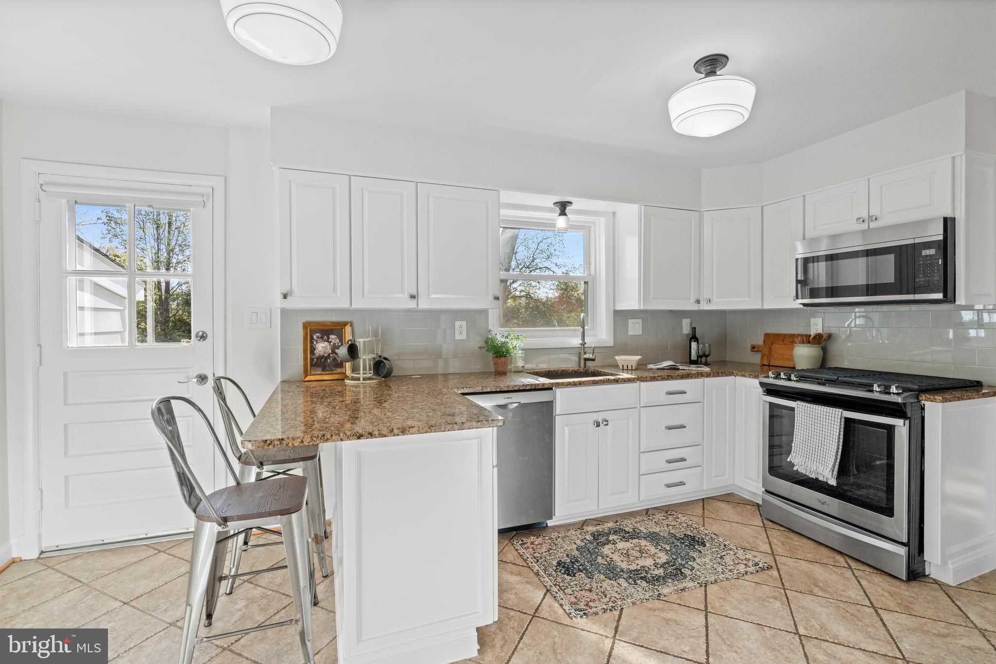 6219 Arkendale Road Alexandria, VA 22307 - Photo 11 of 33 a kitchen with a stove a sink and a microwave