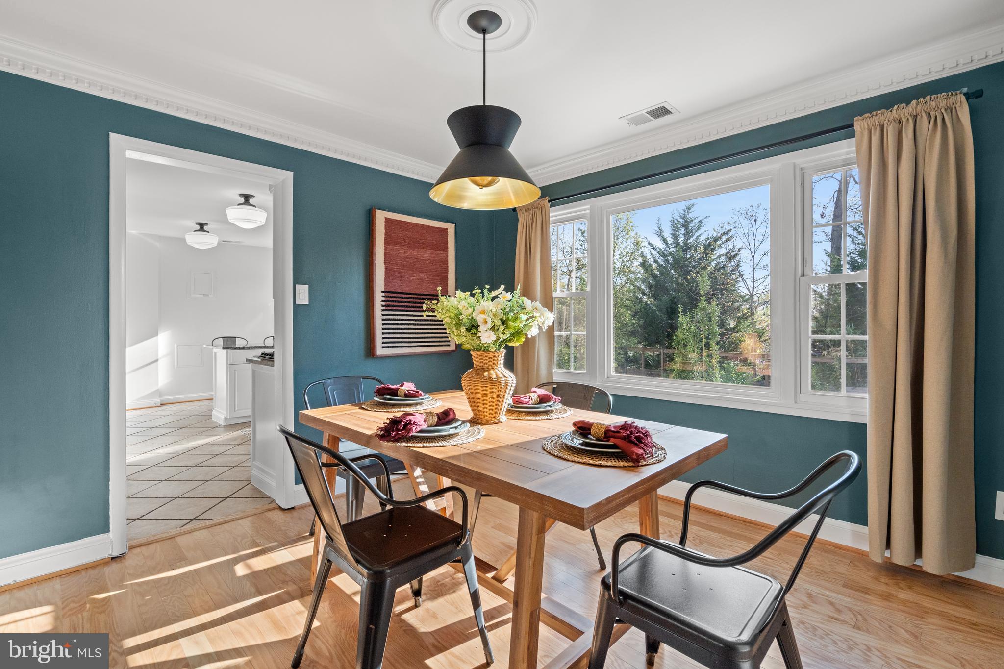 6219 Arkendale Road Alexandria, VA 22307 - Photo 8 of 33 a dining room with furniture wooden floor a chandelier and a rug