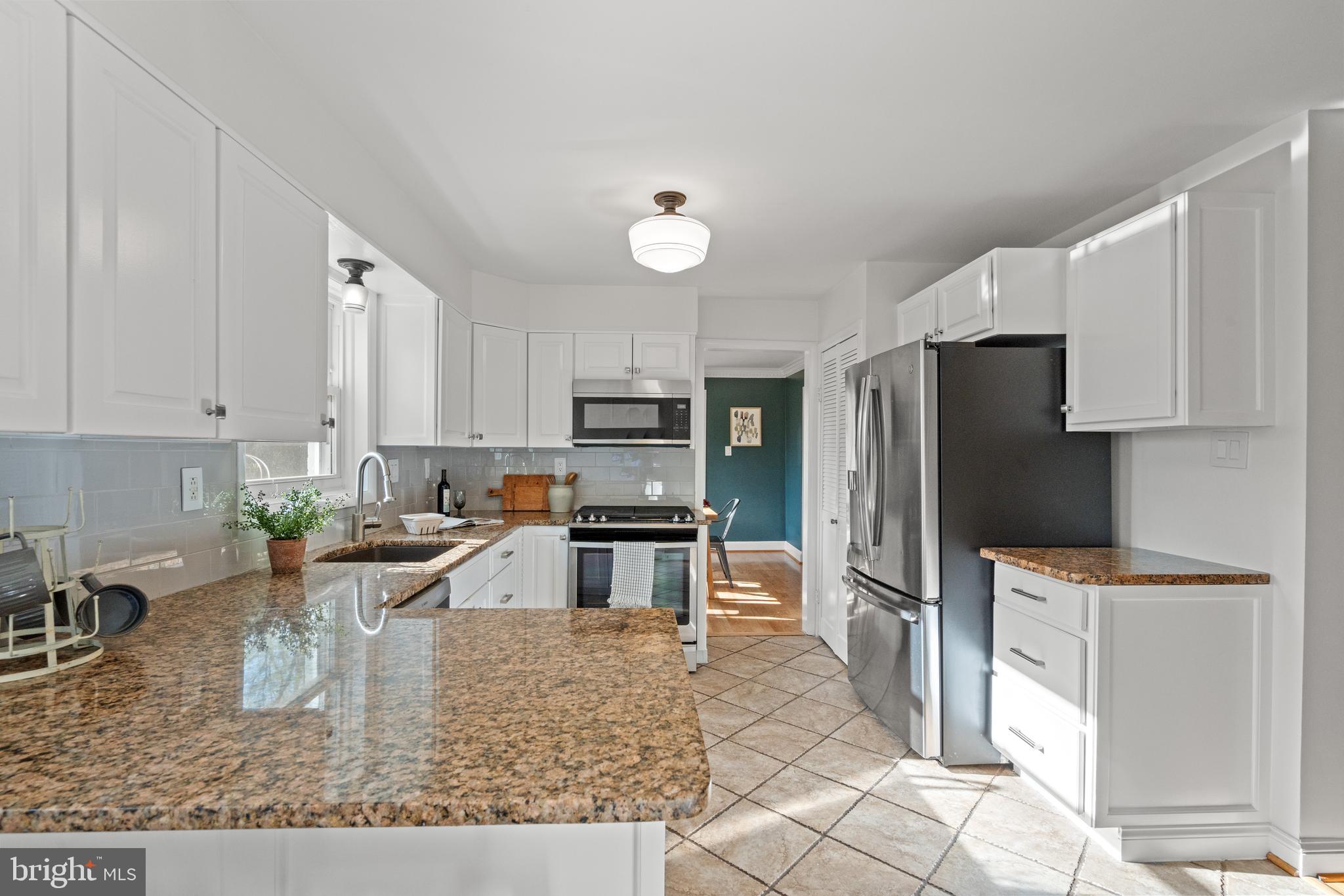 6219 Arkendale Road Alexandria, VA 22307 - Photo 9 of 33 a kitchen with stainless steel appliances granite countertop a refrigerator a stove a sink a stove with white cabinets
