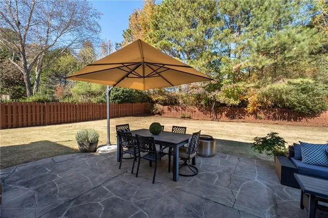 a view of backyard with outdoor seating and trees