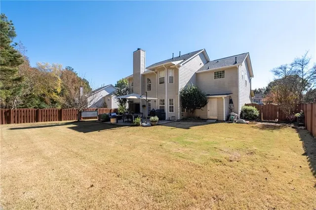 a tall house with a yard in front of it