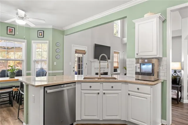a kitchen with cabinets appliances a sink and a window