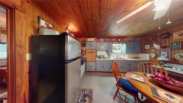 a kitchen with stainless steel appliances granite countertop a refrigerator and a stove top oven