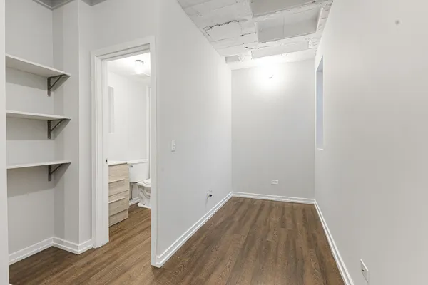 a view of a room with wooden floor and staircase