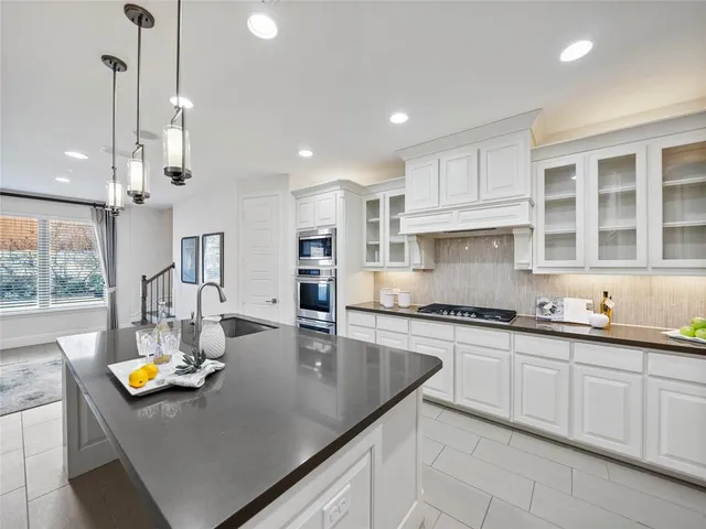 a dining room with furniture and potted plants
