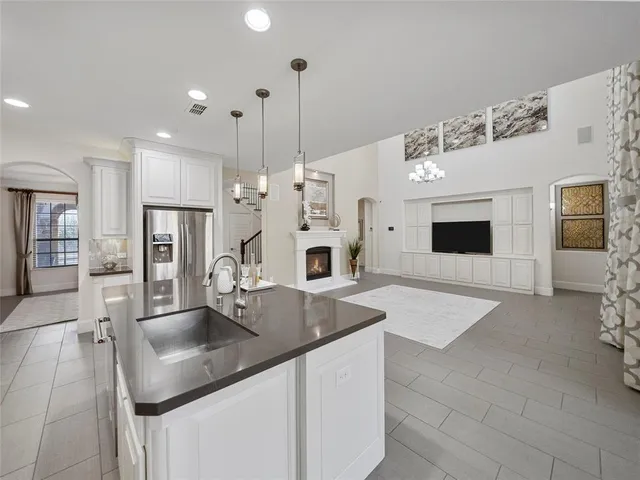 a bedroom with a bed a flat screen tv and a large window