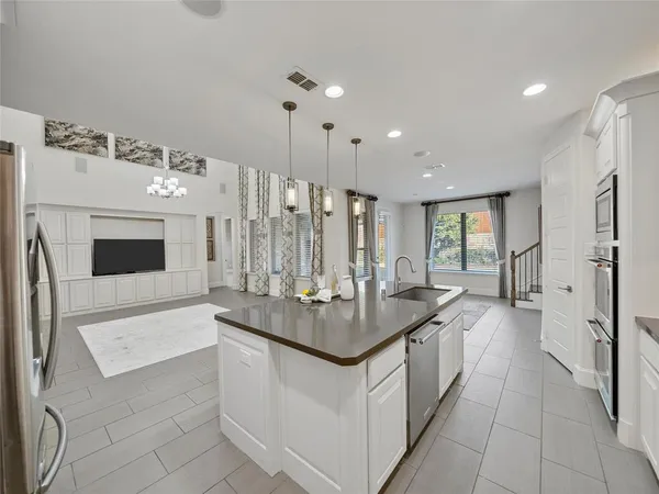 a large bathroom with a sink double vanity granite tub shower and a mirror