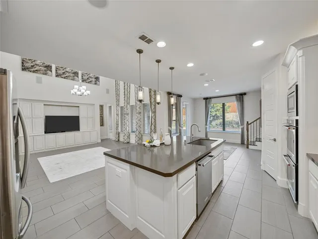 a large bathroom with a sink double vanity granite tub shower and a mirror