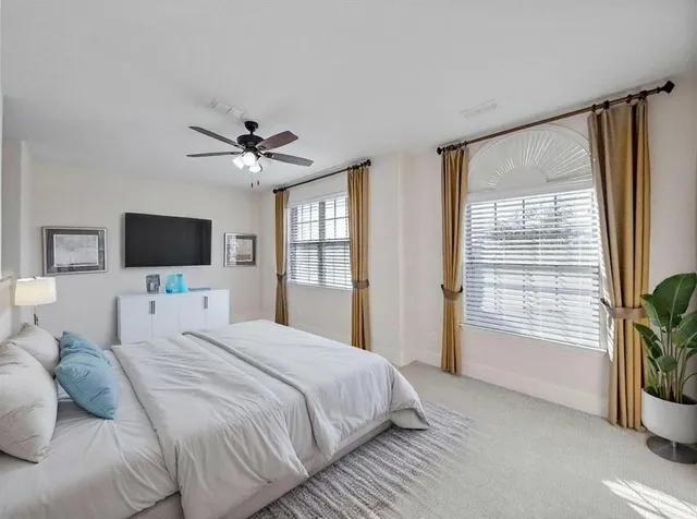 a spacious bathroom with a double vanity sink a mirror and a bathtub