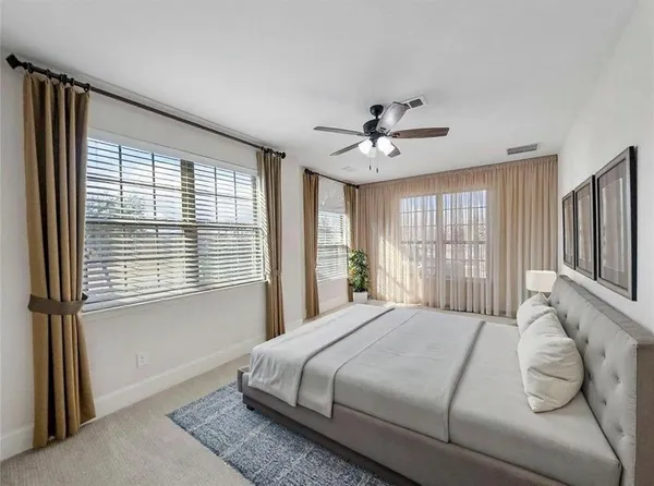 a spacious bathroom with a double vanity sink a mirror and a bathtub