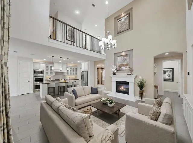 a living room with furniture fireplace and kitchen view