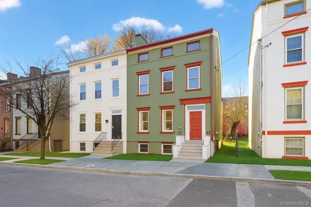 a view of a brick building next to a yard