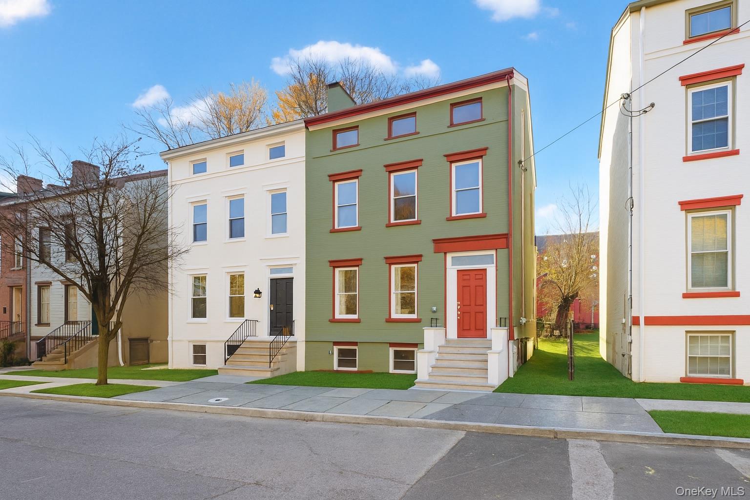 a view of a brick building next to a yard