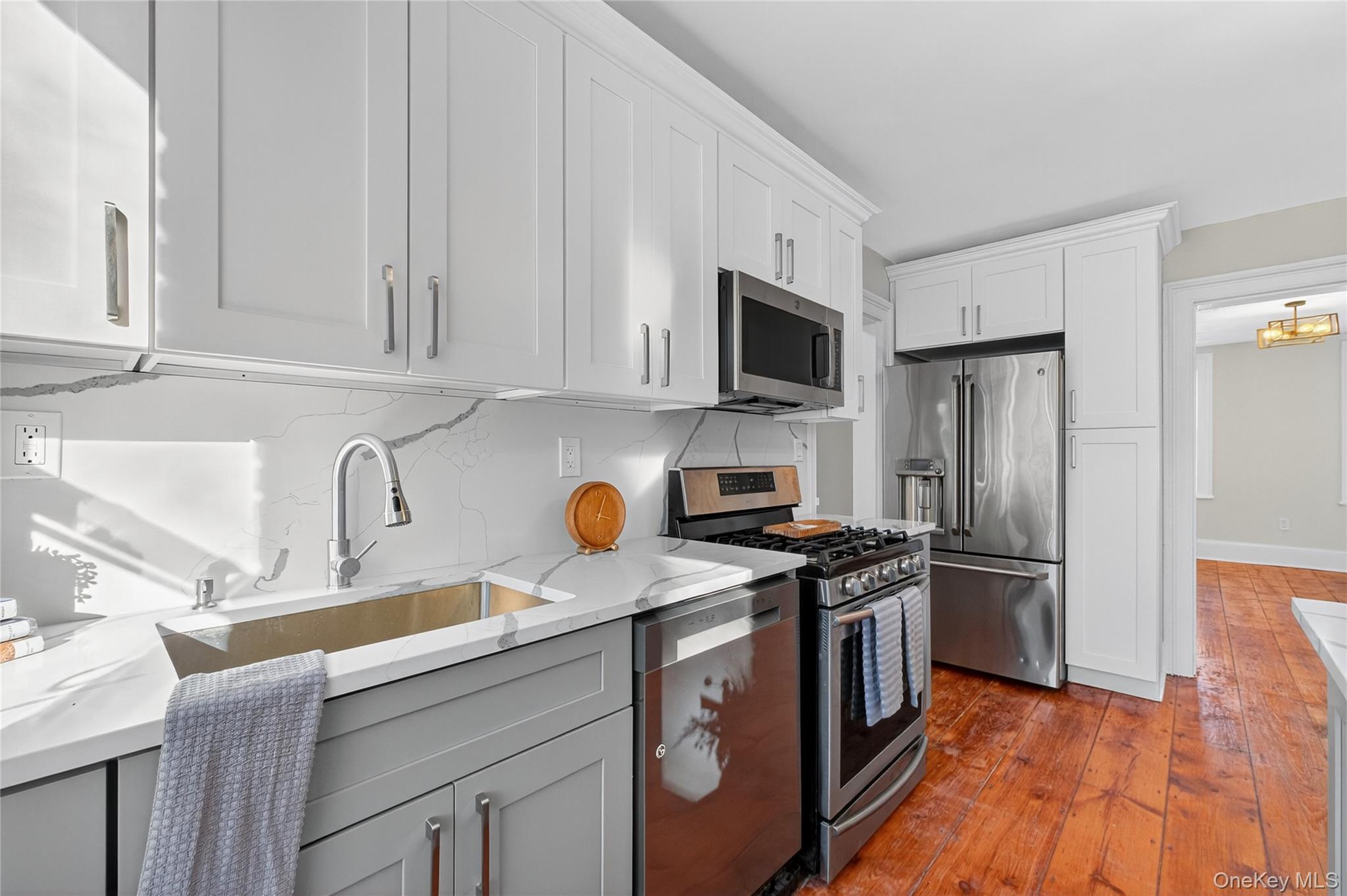 171 Chambers Street, Unit A Newburgh, NY 12550 - Photo 12 of 27 a kitchen with stainless steel appliances a stove a sink a refrigerator and cabinets