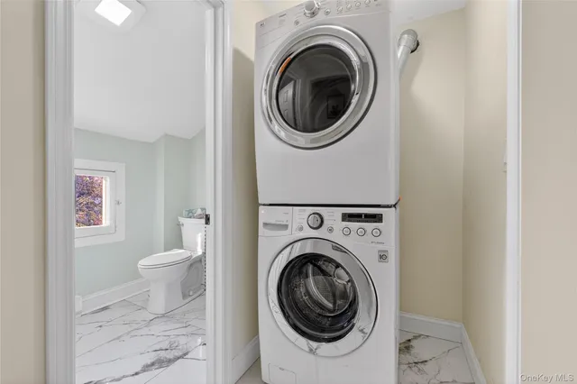 a bathroom with a toilet a sink and a mirror