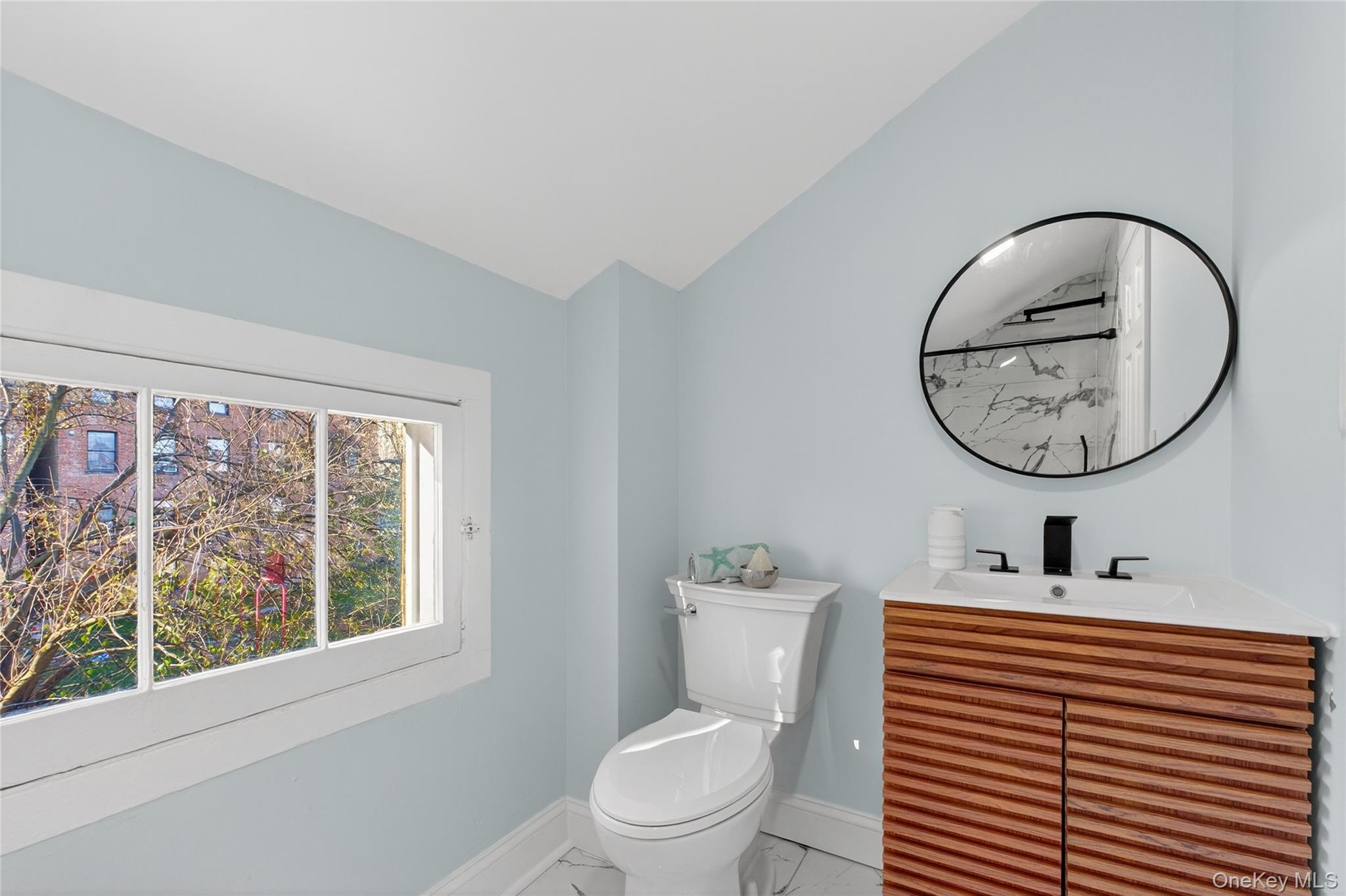 171 Chambers Street, Unit A Newburgh, NY 12550 - Photo 20 of 27 a bathroom with a toilet a sink and a mirror