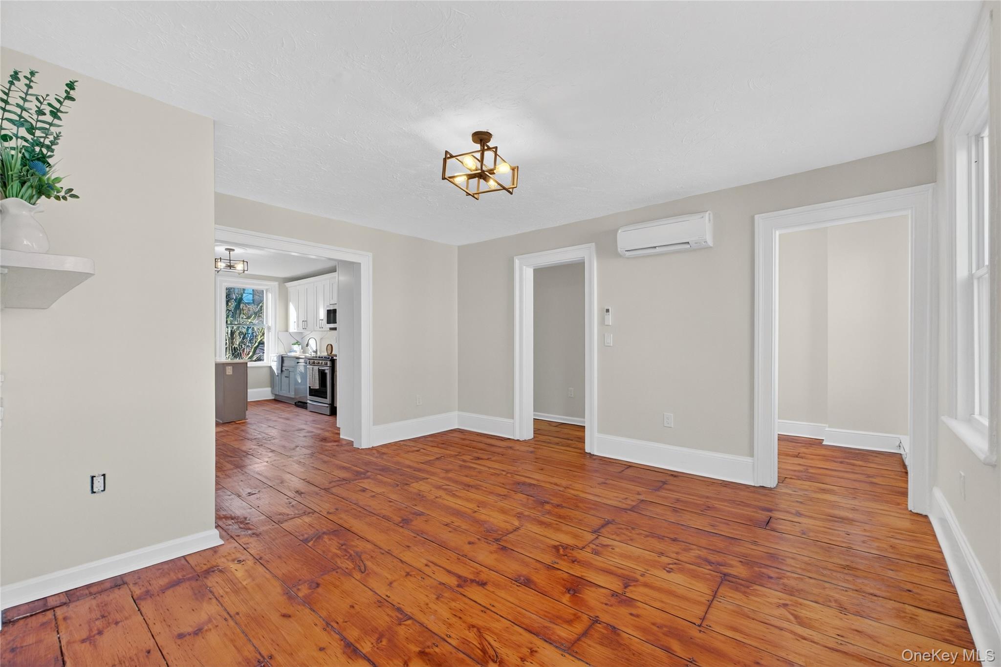171 Chambers Street, Unit A Newburgh, NY 12550 - Photo 4 of 27 wooden floor in an empty room with a workspace