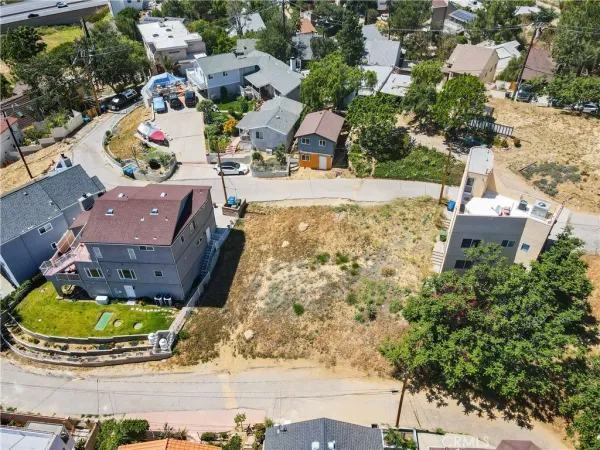 an aerial view of residential houses with yard