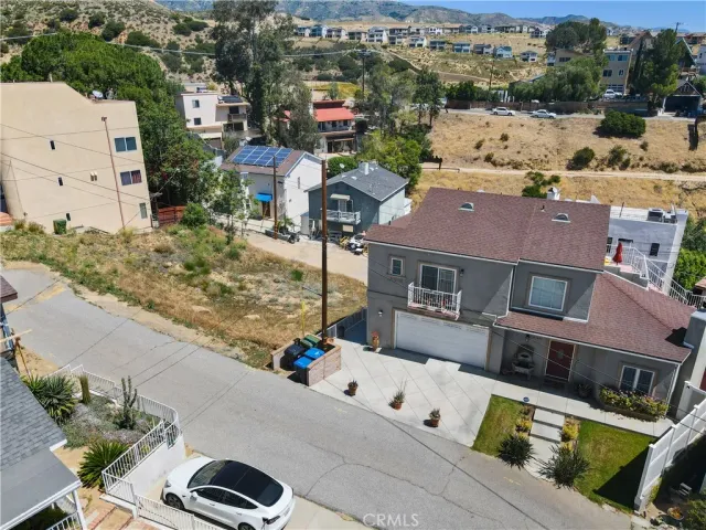 an aerial view of residential houses with outdoor space