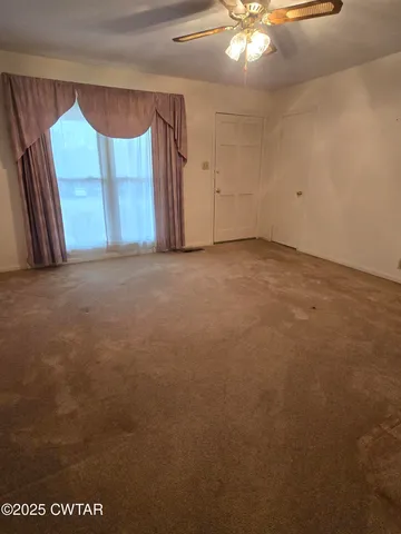 a view of an empty room with a window