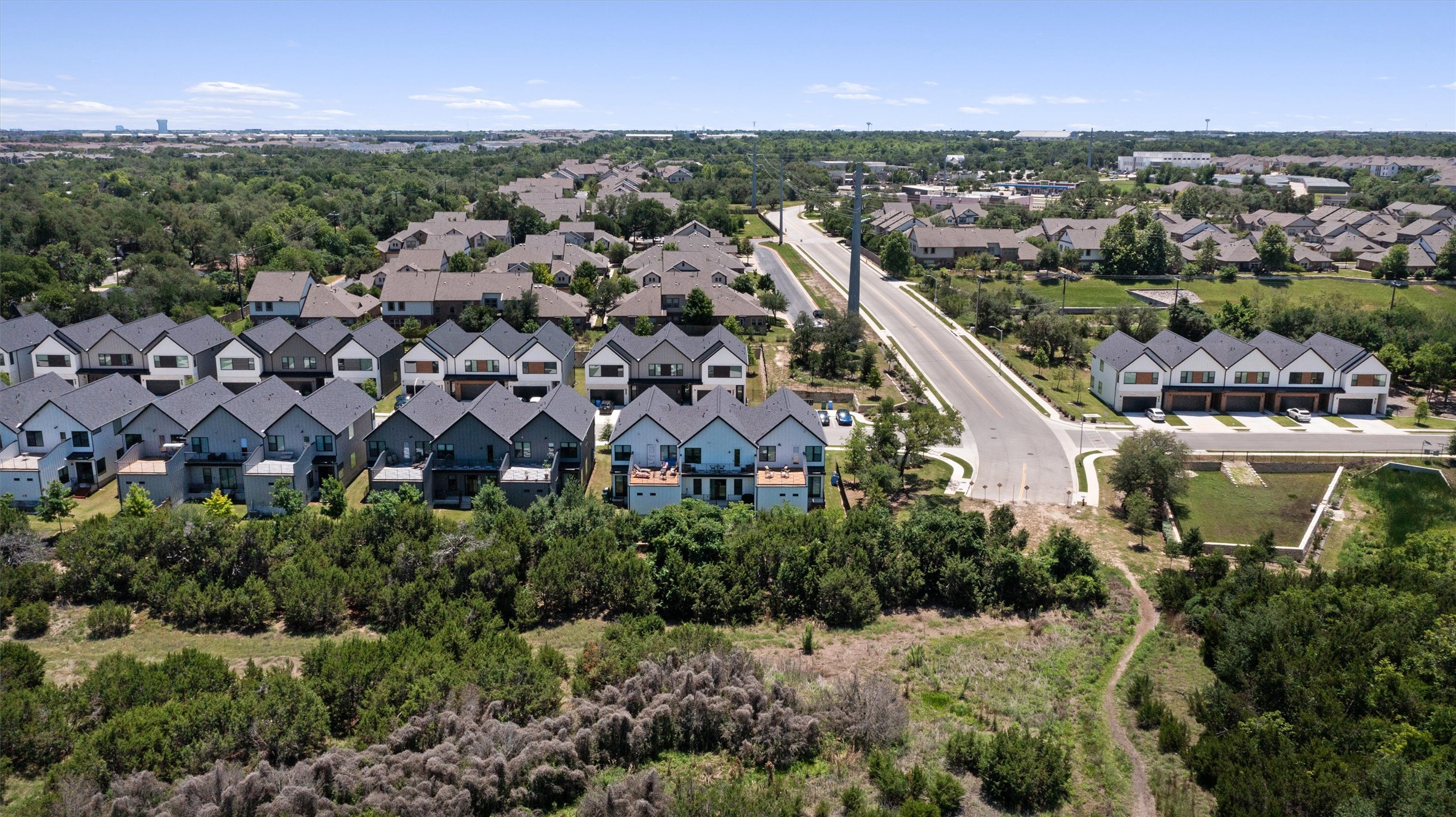 590 Old Mill Road, Unit 153 Cedar Park, TX 78613 - Photo 28 of 40 an aerial view of residential building with parking and trees