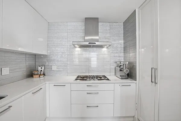 a kitchen with a stove cabinets and a sink