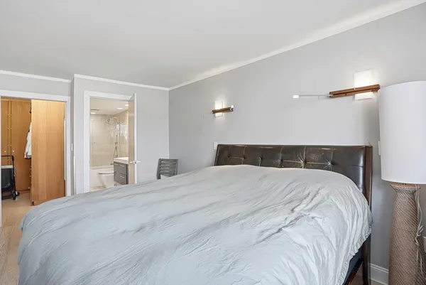a bedroom with a bed and a large mirror