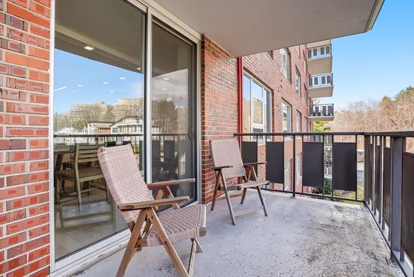 a view of a balcony with chairs
