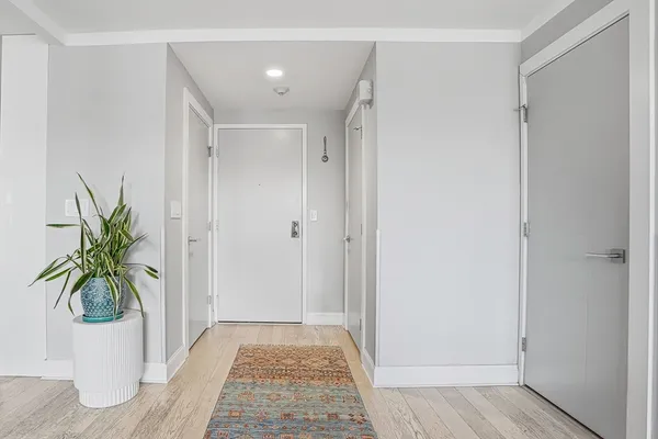 a view of room with a potted plant and wooden floor