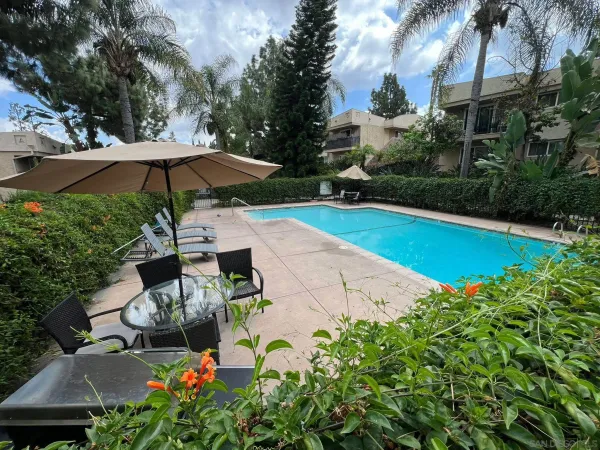 a view of backyard with outdoor seating and trees