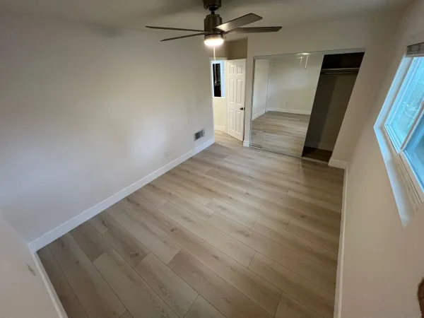 wooden floor in an empty room with a window