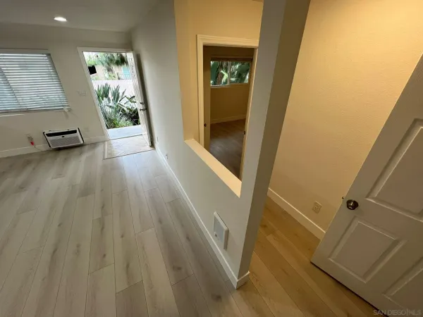 a view of a hallway view with wooden floor and staircase