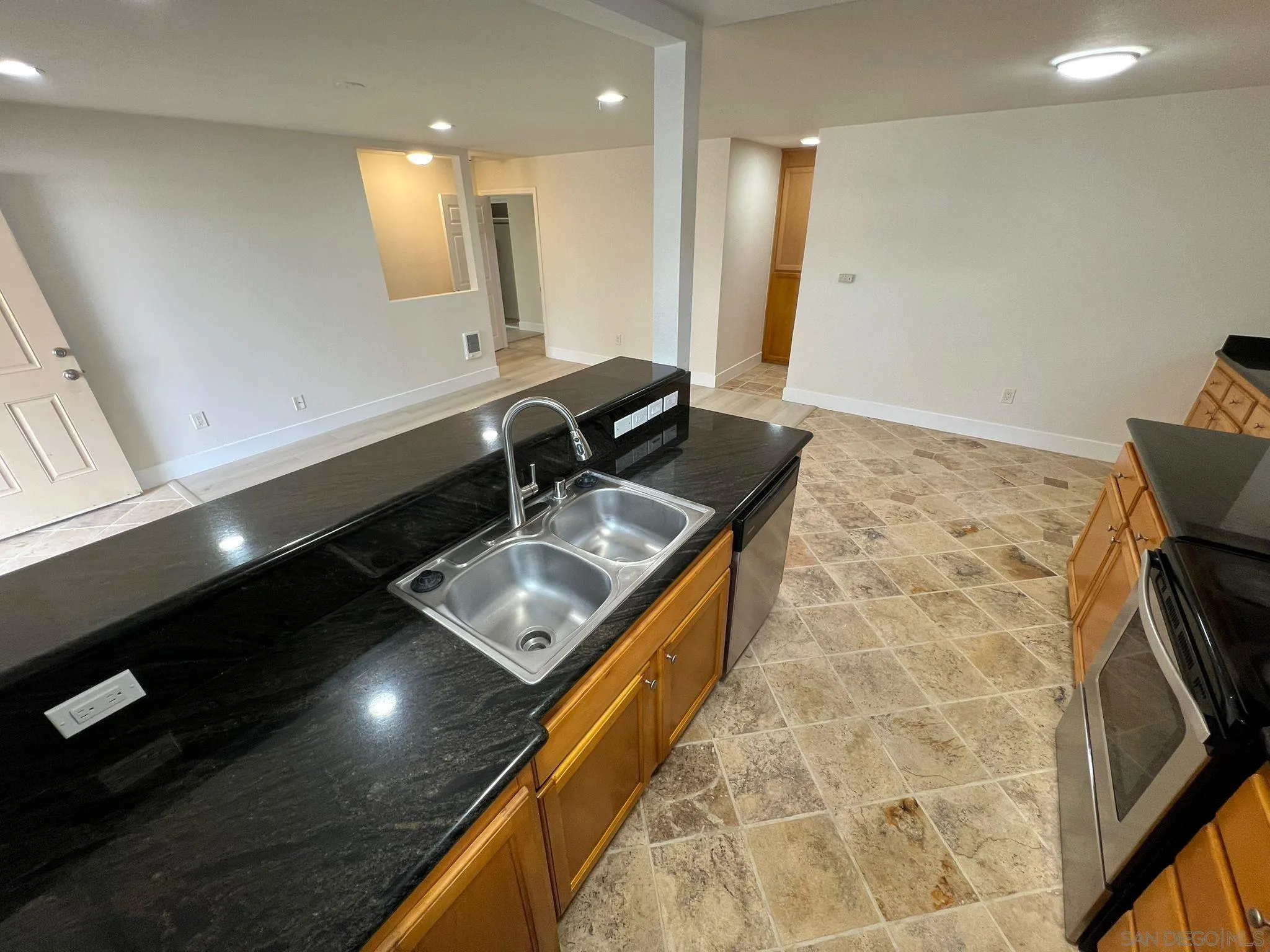 9860 Dale Avenue, Unit D8 Spring Valley, CA 91977 - Photo 6 of 19 a kitchen with a sink a counter top space and a stove top oven